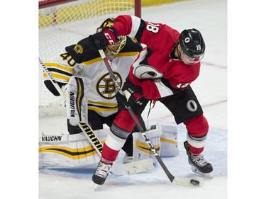 The Ottawa Senators' Ryan Dzingel tries to control the puck in front of Boston Bruins goaltender Tuukka Rask.