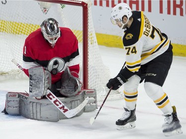 The Boston Bruins' Jake DeBrusk waits for a rebound as a shot hits Ottawa Senators goaltender Mike Condon in the chest during the first period at the CTC on Thursday, Jan. 25, 2018 in Ottawa.