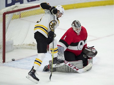 Boston Bruins centre Tim Schaller tries to tip the puck into the net behind Ottawa Senators goaltender Mike Condon during the second period.