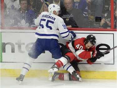 Toronto Maple Leafs defenceman Andreas Borgman checks Ottawa Senators centre Gabriel Dumont into the boards.