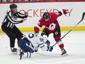 Linesman Derek Amell rushes in as Ottawa Senators left-winger Ryan Dzingel objects to a hit Toronto Maple Leafs defenceman Andreas Borgman laid on teammate Zack Smith.