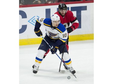 The Senators' Bobby Ryan tries to steal the puck away from the Blues' Brayden Schenn.