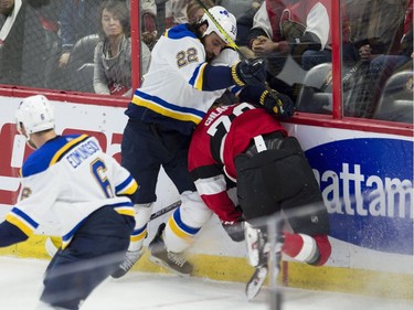 The St. Louis Blues' Chris Thorburn takes the Ottawa Senators' Filip Chlapik into the boards during the second period at the CTC on Thursday, Jan. 18, 2018.