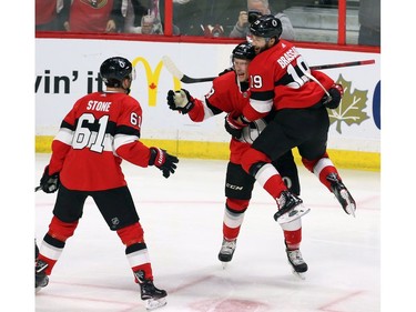 Ottawa Senators left-winger Ryan Dzingel (18) celebrates his goal against the Tampa Bay Lightning with teammates centre Derick Brassard (19) and right-winger Mark Stone (61).