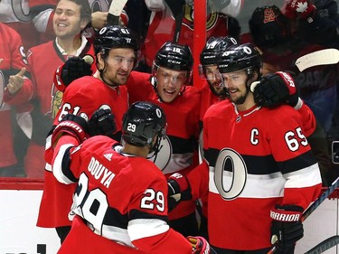 Ottawa Senators left-winger Ryan Dzingel (18) celebrates his goal against the Tampa Bay Lightning with centre Derick Brassard (19) right wing Mark Stone (61) defenceman Erik Karlsson (65) and defenceman Johnny Oduya (29) during the first period in Ottawa on Saturday, Jan. 6, 2018.