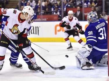 Ottawa Senators left wing Ryan Dzingel (18) watches a shot from defenceman Thomas Chabot, centre, get deflected past Toronto Maple Leafs goaltender Frederik Andersen (31) during first period NHL hockey action in Toronto on Wednesday, January 10, 2018.