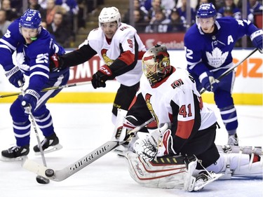 Ottawa Senators goaltender Craig Anderson (41) clears the puck from the front of the net as defenceman Cody Ceci (5) defends against Toronto Maple Leafs left wing James van Riemsdyk (25) and centre Tyler Bozak (42) during second period NHL hockey action in Toronto on Wednesday, January 10, 2018.