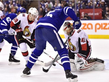 Ottawa Senators goaltender Craig Anderson (41) makes a save on Toronto Maple Leafs left wing James van Riemsdyk (25) as Senators left wing Ryan Dzingel (18) defends during second period NHL hockey action in Toronto on Wednesday, January 10, 2018.