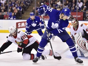 Toronto Maple Leafs left wing James van Riemsdyk (25) tries to play the puck by the side of the net as Ottawa Senators goaltender Craig Anderson (41) looks on while defenceman Erik Karlsson (65) defends during second period NHL hockey action in Toronto on Wednesday, January 10, 2018.