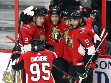 Senators Mike Hoffman celebrates with teammates Dion Phaneuf, top left, Cody Ceci (5) Bobby Ryan (9), Matt Duchene (95) and Mark Stone (61) after tying the score 5-5 with his goal in the third period.