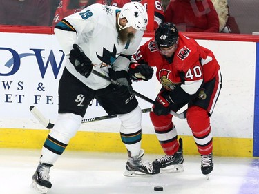 The San Jose Sharks' Joe Thornton fights for possession of the puck with the Ottawa Senators' Gabriel Dumont during the first period at the CTC on Friday, Jan. 5, 2018.