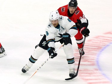 The San Jose Sharks' Joe Pavelski (8) is chased by the Ottawa Senators' Jean-Gabriel Pageau.