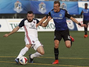 Colin Falvey, left, in action with Indy Eleven against FC Edmonton's Dean Shiels during an NASL match last season.