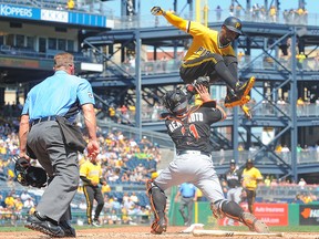 Andrew McCutchen of the Pittsburgh Pirates is tagged out at home plate by J.T. Realmuto of the Miami Marlins on June 11, 2017 in Pittsburgh.