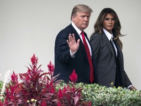 In this Wednesday, Oct. 11, 2017 file photo, President Donald Trump walks along the Colonnade with first lady Melania Trump on his way to board the Marine One helicopter on the South Lawn of the White House in Washington.