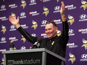 Minnesota Vikings head coach Mike Zimmer waves as fans look into his post-game press conference in Minneapolis, Sunday, Jan. 14, 2018. (AP Photo/Jim Mone)