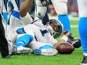 Carolina Panthers quarterback Cam Newton lies on the field after being sacked during an NFL NFC wild-card playoff football game against the New Orleans Saints on Jan. 7, 2018