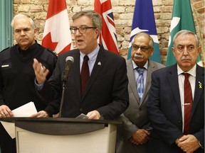 Ottawa Mayor Jim Watson, joined by Ottawa police Chief Charles Bordeleau, left, and councillors Shad Qadri and Eli El-Chantiry, right, provided an update on the Ottawa Street Violence and Gang Strategy at city hall on Friday, Jan. 26, 2018.