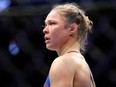 In this Dec. 30, 2016, file photo, Ronda Rousey stands in the cage after Amanda Nunes forced a stoppage in the first round of their women's bantamweight championship mixed martial arts bout at UFC 207 in Las Vegas