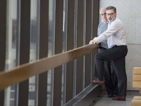 Jean Demaître, right, speaks with his lawyer, Gaétan Bourassa, as the jury enters its seventh day of deliberations Wednesday, Jan. 17, 2018 in Sherbrooke.