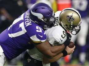 In this Sept. 11, 2017, file photo, New Orleans Saints quarterback Drew Brees (9) is sacked by Minnesota Vikings defensive end Everson Griffen (97) during the first half of an NFL football game in Minneapolis.  (AP Photo/Jim Mone, File)