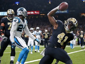 In this Dec. 3, 2017, file photo, New Orleans Saints running back Alvin Kamara (41) celebrates his touchdown in front of Carolina Panthers cornerback James Bradberry (24) in New Orleans.