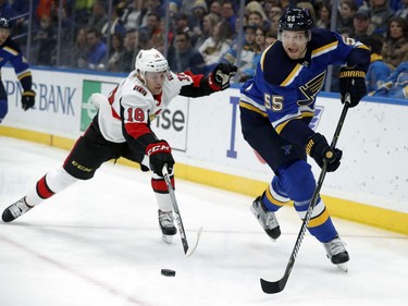 St. Louis Blues' Colton Parayko (55) passes the puck as Ottawa Senators' Ryan Dzingel (18) defends during the first period of an NHL hockey game Tuesday, Jan. 23, 2018, in St. Louis.