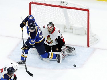 St. Louis Blues' Alexander Steen (20) and Ottawa Senators goaltender Craig Anderson watch as a puck slides by during the first period of an NHL hockey game Tuesday, Jan. 23, 2018, in St. Louis.