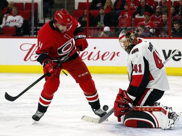 Carolina Hurricanes' Justin Williams (14) waits for the rebound from Ottawa Senators goaltender Craig Anderson (41) during the second period of an NHL hockey game, Tuesday, Jan. 30, 2018, in Raleigh, N.C.