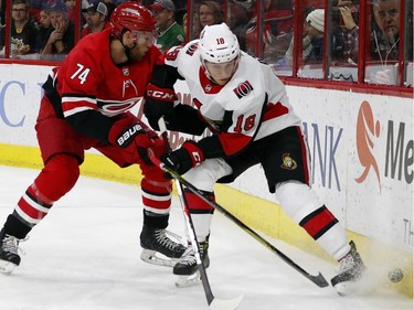 Ottawa Senators' Ryan Dzingel (18) battles with Carolina Hurricanes' Jaccob Slavin (74) during the first period of an NHL hockey game, Tuesday, Jan. 30, 2018, in Raleigh, N.C.