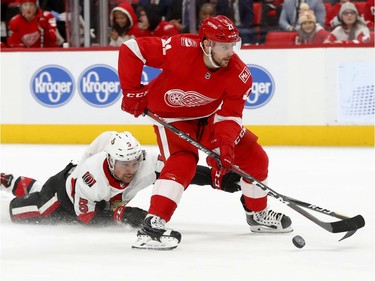 Ottawa Senators defenceman Cody Ceci tries to dive for the puck as the Detroit Red Wings' Tomas Tatar skates with it during the second period.