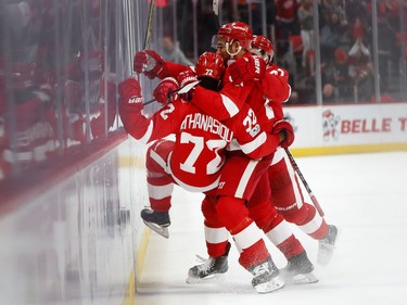 The Detroit Red Wings' Andreas Athanasiou celebrates his overtime goal with teammates.