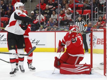Ottawa Senators right wing Mark Stone (61) knocks the puck toward the net, but Detroit Red Wings goaltender Jimmy Howard (35) deflects it during the first period of an NHL hockey game Wednesday, Jan. 3, 2018, in Detroit.