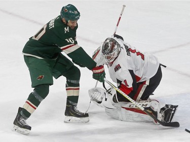A shot by Minnesota Wild's Chris Stewart, left, goes wide as Ottawa Senators goaltender Mike Condon defends in the second period of an NHL hockey game Monday, Jan. 22, 2018, in St. Paul, Minn.