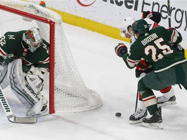 Minnesota Wild goalie Alex Stalock, left, watches as teammate Jonas Brodin, right, of Sweden, tries to fend off Ottawa Senators' Matt Duchene in the first period of an NHL hockey game Monday, Jan. 22, 2018, in St. Paul, Minn.