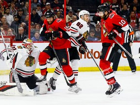 Ottawa Senators' Zack Smith and Tom Pyatt screen Chicago Blackhawks goaltender Anton Forsberg during NHL action at the Canadian Tire Centre on Jan. 9, 2018