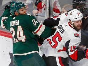 Ottawa Senators' Zack Smith, right, tries to break free from Minnesota Wild's Matt Dumba in the first period of an NHL game on Jan. 22, 2018