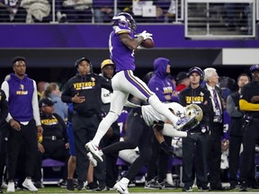 Minnesota Vikings wide receiver Stefon Diggs  makes a catch over New Orleans Saints free safety Marcus Williams (43) on his way to the game winning touchdown during the second half of an NFL divisional football playoff game in Minneapolis, Sunday, Jan. 14, 2018. (AP Photo/Jeff Roberson)