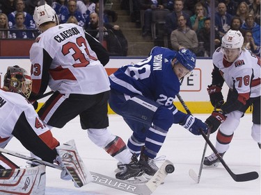 Toronto Maple Leafs right wing Connor Brown (28) fights for the puck in the first period, as the Toronto Maple Leafs take on the Ottawa Senators at the Air Canada Centre in Toronto on Thursday January 11, 2018. Stan Behal/Toronto Sun/Postmedia Network