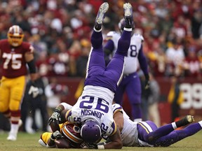 Running back Chris Thompson of the Washington Redskins is tackled by defensive tackle Tom Johnson of the Minnesota Vikings on Nov. 12, 2017