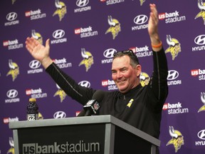 Minnesota Vikings head coach Mike Zimmer waves as fans looked into his post-game press conference following a 29-24 win over the New Orleans Saints an NFL divisional football playoff game in Minneapolis, Sunday, Jan. 14, 2018. (AP Photo/Jim Mone)