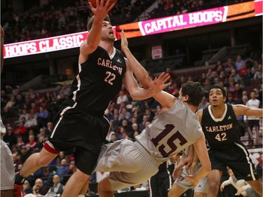 The Ravens' Mitch Wood goes up for a basket as the GeeGees' Brody Maracle tries to draw a charging foul. Jana Chytilova/Postmedia