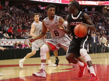 The GeeGees' Chase Tynes (6) defends against the Ravens Munis Tutu as he drives to the hoop. Jana Chytilova/Postmedia