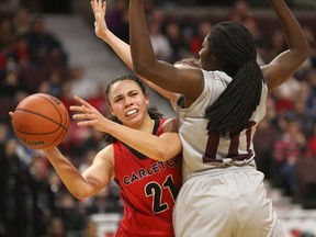 Carleton's Elizabeth Leblanc, trying to pass the ball past Ottawa's Adonaelle Mousamboté during the Capital Hoops Classic game on Feb. 2, was named OUA women's basketball defensive player of the year on Tuesday. Jana Chytilova/Postmedia