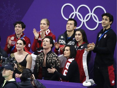 Canada's Tessa Virtue and Scott Moir wait in the "kiss and cry" area after competing during the figure skating ice dance team event on Sunday. Leah Hennel/Postmedia
