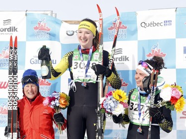 First-place Madison Fraser, centre, second-place Jessica Roach, right, and third-place Christa Ramonat, left, celebrate at the medal ceremony for the women's 27K classic race on Saturday. Patrick Doyle/Postmedia