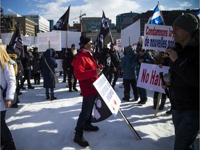 Anti-Muslim and anti-racism protestors voiced clashing views on Parliament Hill on Sunday.   Ashley Fraser/Postmedia