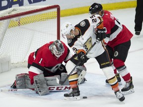 Anaheim Ducks winger Ondrej Kase tries to put the puck past Ottawa Senators goaltender Mike Condon while under pressure from Ryan Dzingel during Thursday night's game. (THE CANADIAN PRESS)