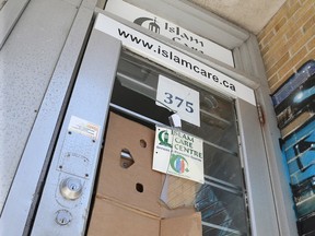 Damage to the front door of the Islam Care Centre at 375 Somerset St. in April 2017 is covered up with cardboard.