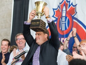 Team president David Gourlay hoists the cup as the Ottawa Champions are given a heroes welcome at Ottawa City Hall following their victory in the Can-Am League Championship.